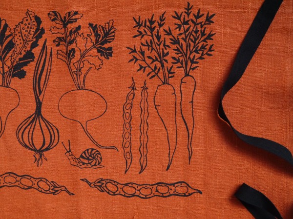 Vegetable detail of orange linen apron